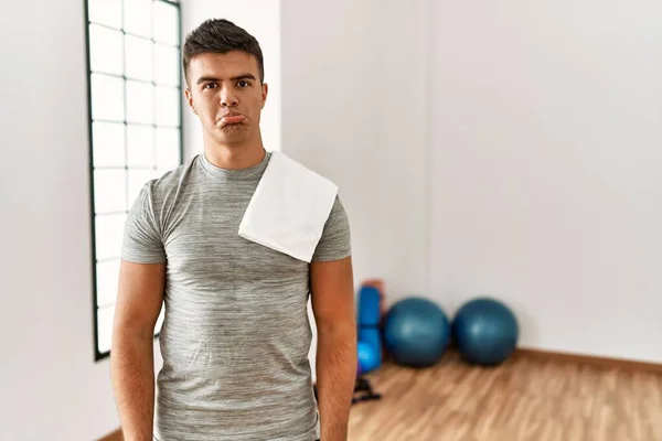 Young Hispanic Man Wearing Sportswear Towel Gym Depressed Worry Distress — Stok fotoğraf