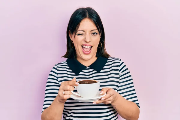 Young Hispanic Woman Drinking Cup Coffee Winking Looking Camera Sexy — Stock Photo, Image