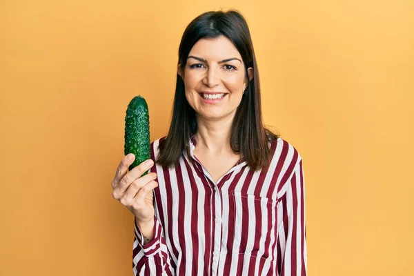 Young Hispanic Woman Holding Cucumber Looking Positive Happy Standing Smiling — Foto Stock