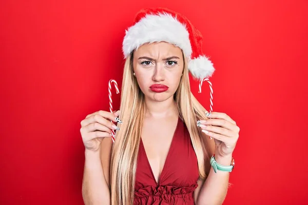 Jong Blond Meisje Draagt Kerstmuts Met Snoep Sceptisch Nerveus Fronsend — Stockfoto