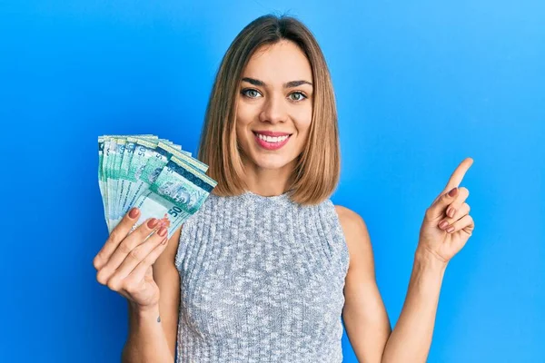 Young Caucasian Blonde Woman Holding Malaysia Ringgit Banknotes Smiling Happy — Stock Photo, Image