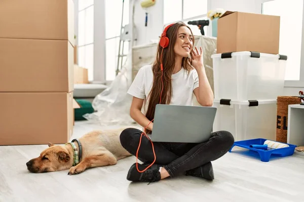Young Hispanic Woman Listening Music Sitting Floor Dog New Home — Stockfoto