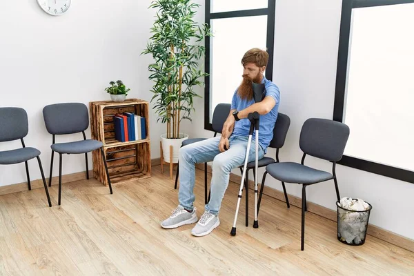 Ung Rödhårig Man Med Kryckor Sittande Stolen Kliniken Väntrum — Stockfoto