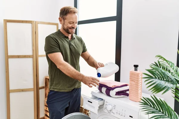 Middle Age Hispanic Man Smiling Confident Using Detergent Laundry Room — Stockfoto