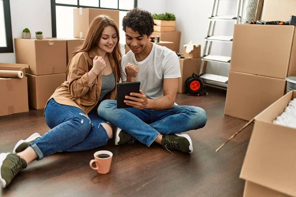 Young Couple Smiling Happy Using Touchpad Drinking Coffee New Home — Stock Photo, Image