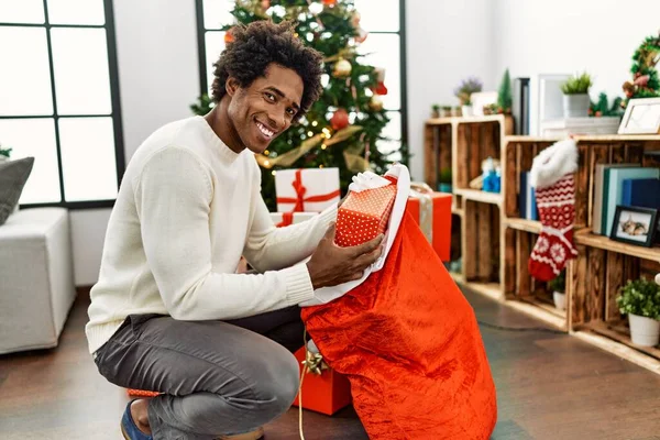 Young African American Man Holding Gifts Santa Claus Bag Home — Stock Photo, Image