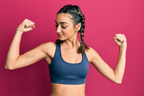 Young Brunette Girl Wearing Sportswear Braids Showing Arms Muscles Smiling — Stock Photo, Image