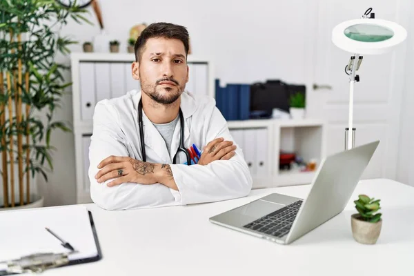 Young Doctor Working Clinic Using Computer Laptop Skeptic Nervous Disapproving — Stockfoto