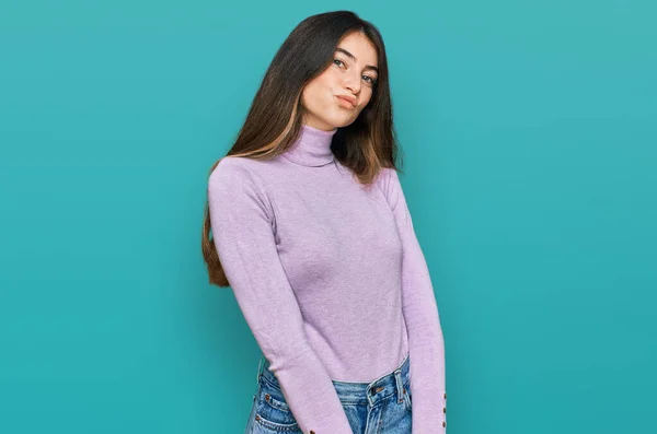 Young Beautiful Teen Girl Wearing Turtleneck Sweater Looking Camera Blowing — Stockfoto