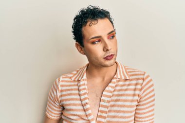 Handsome man wearing make up wearing casual shirt smiling happy and positive, thumb up doing excellent and approval sign 