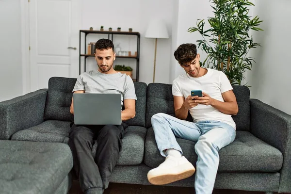 Two Hispanic Men Couple Using Smartphone Laptop Home — Stock Photo, Image