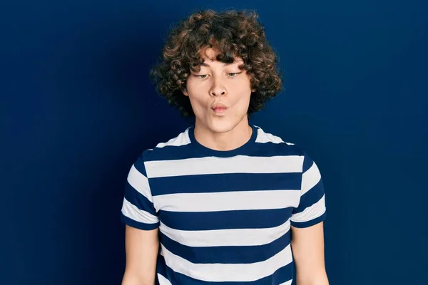 Handsome Young Man Wearing Casual Striped Shirt Making Fish Face — Zdjęcie stockowe