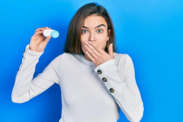 Young Caucasian Girl Holding Contact Lenses Covering Mouth Hand Shocked — Fotografia de Stock