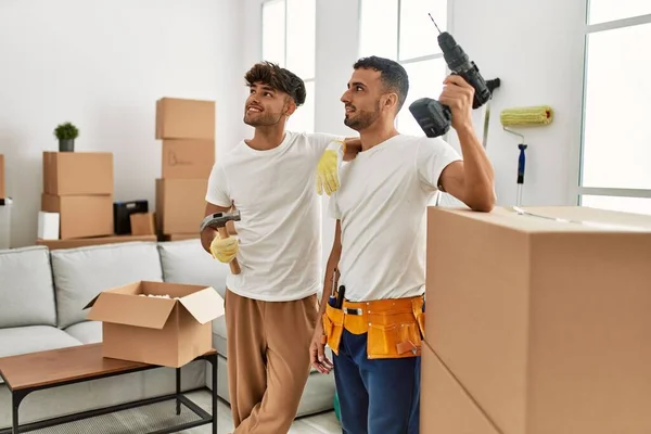 Two Hispanic Men Couple Smiling Confident Repairing House New Home — ストック写真
