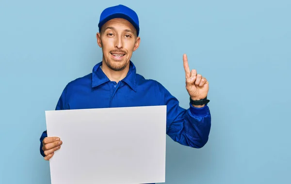 Bald Man Beard Wearing Builder Jumpsuit Uniform Holding Empty Banner — Foto de Stock