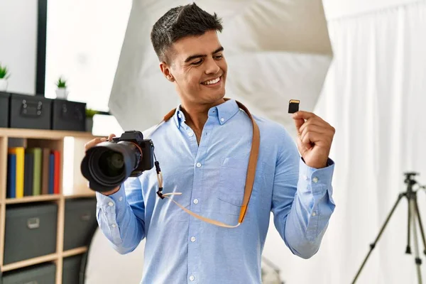 Young Hispanic Man Photographer Holding Professional Camera Memory Card Photography — Φωτογραφία Αρχείου