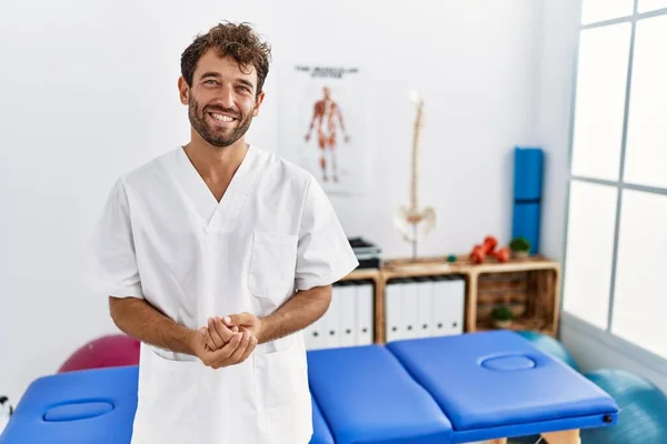 Young Handsome Physiotherapist Man Working Pain Recovery Clinic Hands Together — Stockfoto