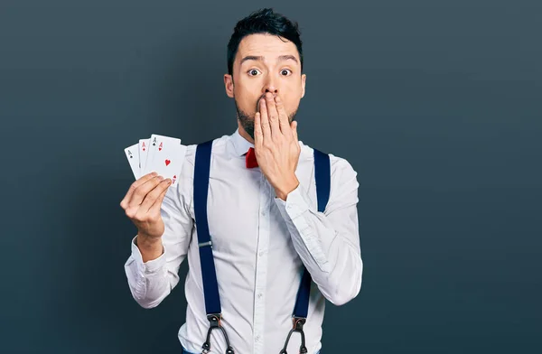 Hispanic Man Beard Holding Poker Cards Covering Mouth Hand Shocked — Fotografia de Stock