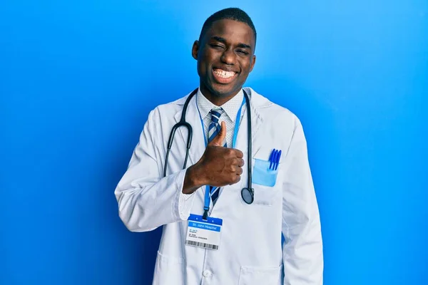 Young African American Man Wearing Doctor Uniform Doing Happy Thumbs — Stock Photo, Image