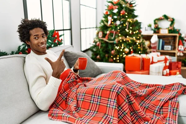 Young African American Man Sitting Sofa Drinking Coffee Christmas Tree — Fotografia de Stock