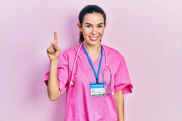 Young Brunette Woman Wearing Doctor Uniform Stethoscope Showing Pointing Finger — Fotografia de Stock