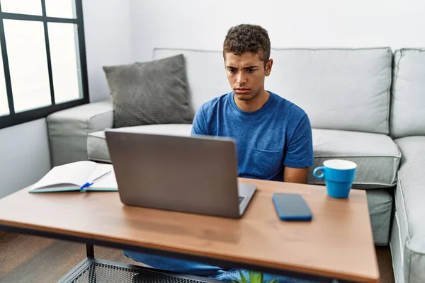 Young Handsome Hispanic Man Using Laptop Sitting Floor Skeptic Nervous — Photo