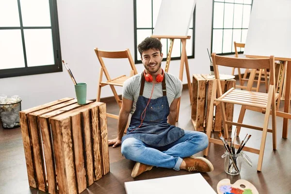 Young Hispanic Man Sitting Art Studio Happy Cool Smile Face — Stok fotoğraf