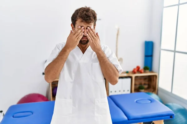 Young Handsome Physiotherapist Man Working Pain Recovery Clinic Rubbing Eyes — Stockfoto