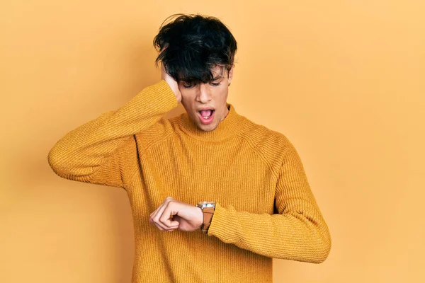 Handsome Hipster Young Man Wearing Casual Yellow Sweater Looking Watch — Foto Stock