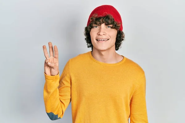 Handsome Young Man Wearing Wool Hat Showing Pointing Fingers Number — Stock fotografie