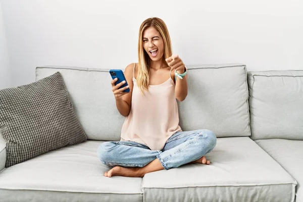 Blonde Beautiful Young Woman Sitting Sofa Home Using Smartphone Pointing — Fotografia de Stock
