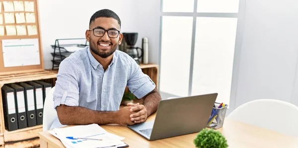 Young arab man smiling confident working at office