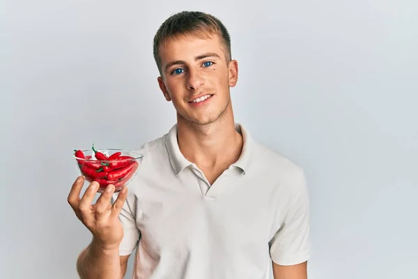Young Caucasian Man Holding Bowl Red Pepper Looking Positive Happy — Fotografia de Stock
