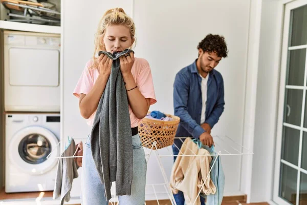 Young Couple Smiling Happy Doing Laundry Woman Smelling Clean Clothes — Stock Photo, Image