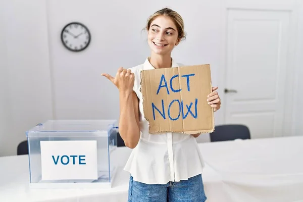 Young Blonde Woman Political Election Holding Act Now Banner Pointing — Stock fotografie