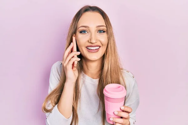 Young Blonde Girl Using Smartphone Drinking Cup Coffee Smiling Laughing — Fotografie, imagine de stoc