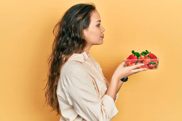 Young Hispanic Girl Holding Strawberries Looking Side Relax Profile Pose — Stockfoto