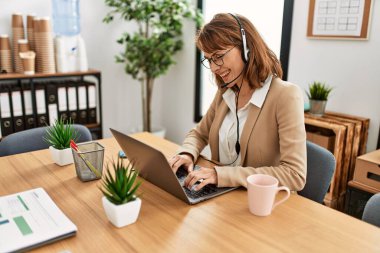 Ofiste çalışırken gülümseyen Kafkasyalı bir çağrı merkezi ajanı..