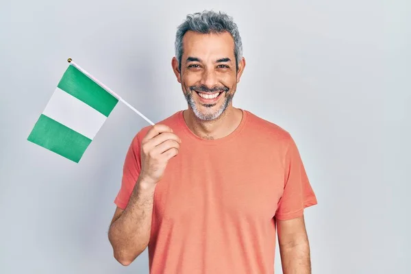 Handsome Middle Age Man Grey Hair Holding Nigeria Flag Looking — Stock fotografie