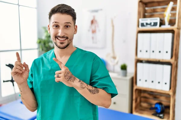 Young Physiotherapist Man Working Pain Recovery Clinic Smiling Looking Camera — Stok fotoğraf