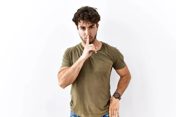Hispanic Man Standing Isolated White Background Asking Quiet Finger Lips — 스톡 사진