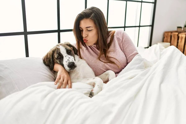 Ung Kvinna Kysser Och Kramar Hund Sitter Sängen Sovrummet — Stockfoto