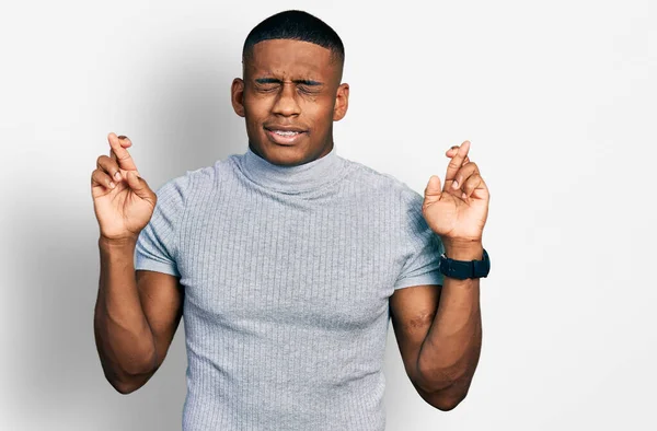 Young Black Man Wearing Casual Shirt Gesturing Finger Crossed Smiling — Stockfoto