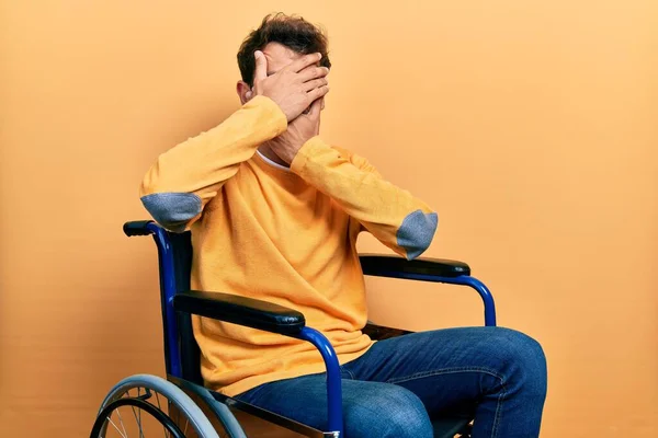 Handsome Man Beard Sitting Wheelchair Covering Eyes Mouth Hands Surprised — Foto Stock