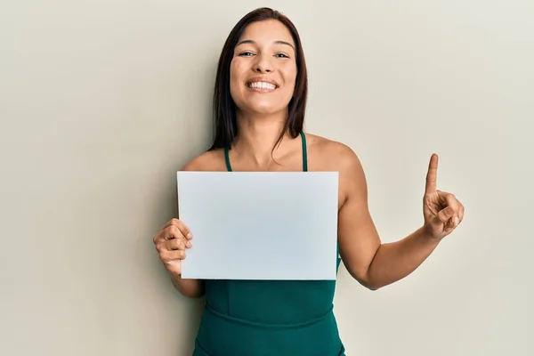 Young Latin Woman Holding Blank Empty Banner Smiling Idea Question — Foto Stock