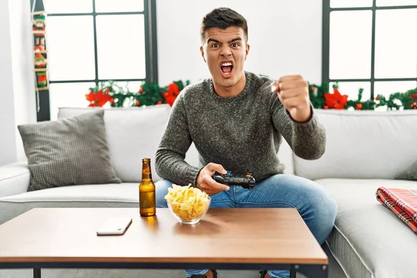Young Hispanic Man Playing Video Game Christmas Annoyed Frustrated Shouting — Stock fotografie