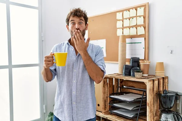 Young Handsome Man Drinking Cup Coffee Office Covering Mouth Hand — Photo