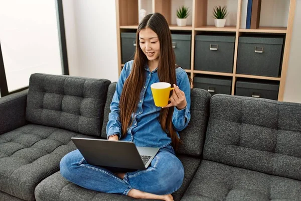 Νεαρή Κινέζα Χρησιμοποιώντας Φορητό Υπολογιστή Και Πίνοντας Καφέ Κάθεται Στον — Φωτογραφία Αρχείου