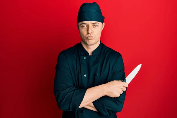 Handsome Young Man Wearing Professional Cook Uniform Holding Knife Depressed — Stockfoto