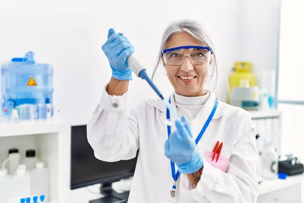 Middle Age Grey Haired Woman Wearing Scientist Uniform Using Pipette — Stock Photo, Image